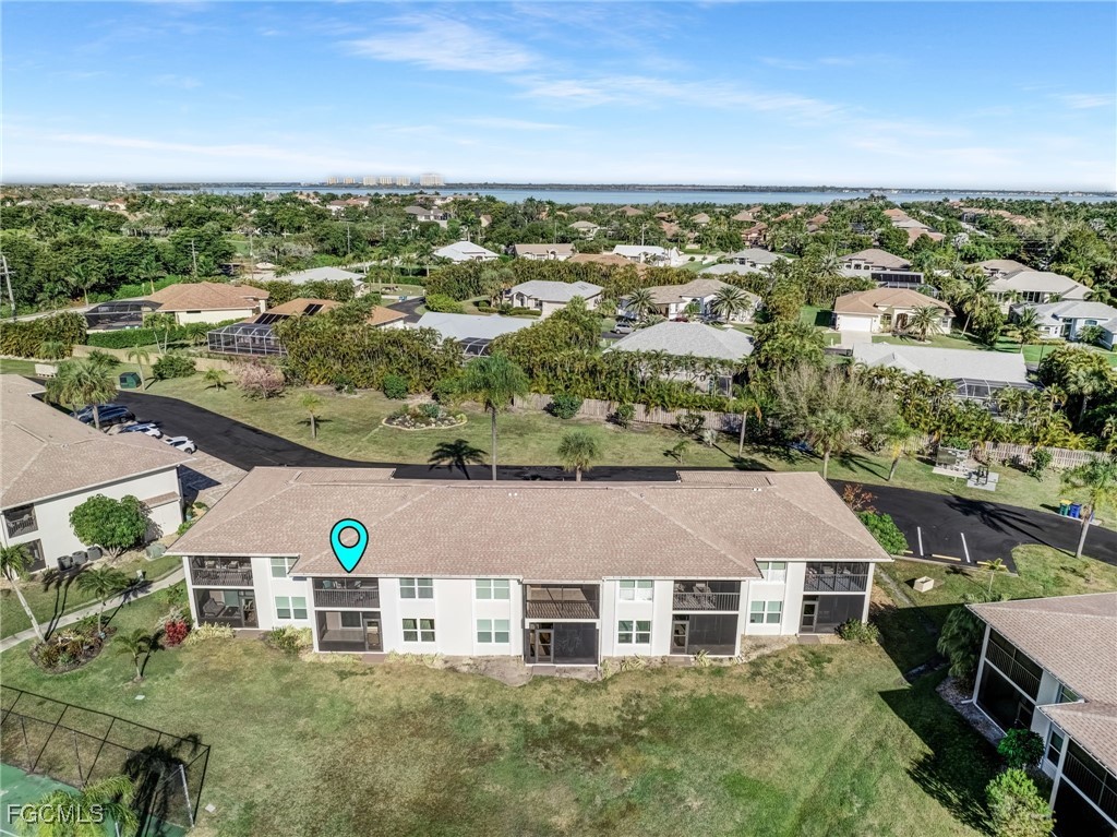 16007 Davis Road, Unit 524 Fort Myers, FL 33908 - Photo 34 of 36 an aerial view of residential houses with outdoor space and trees