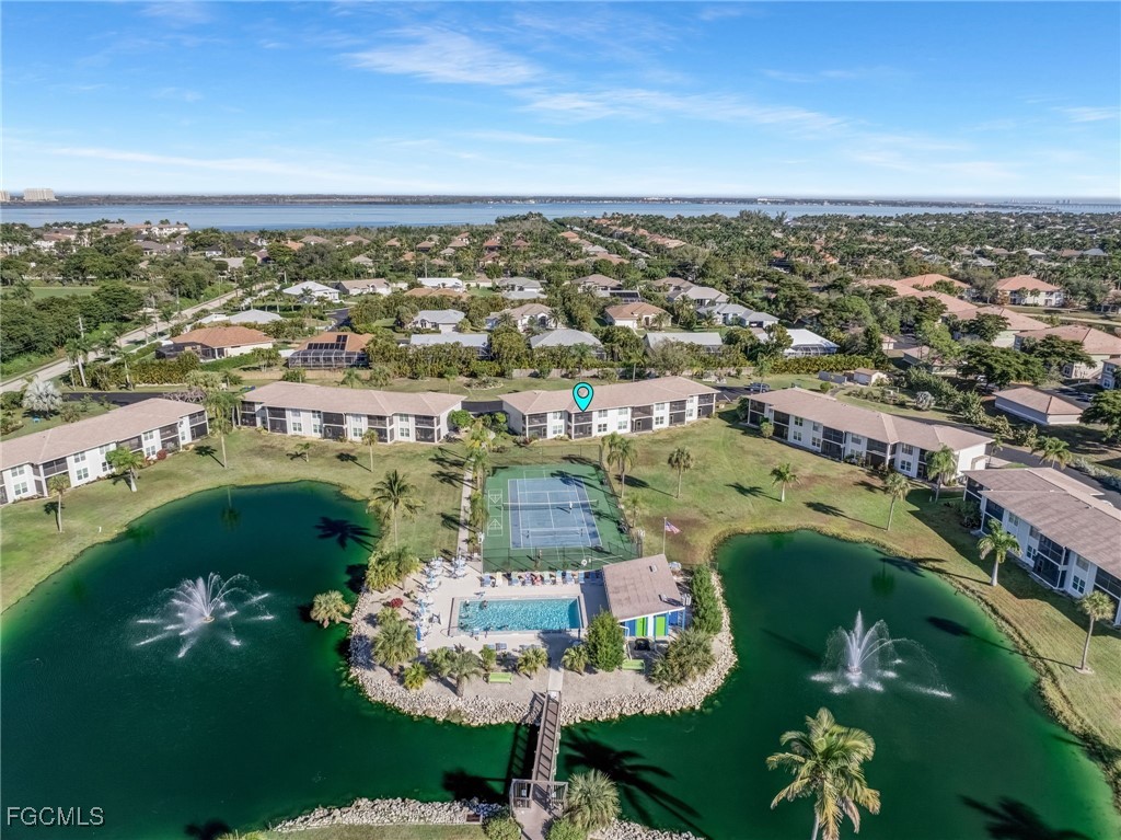 16007 Davis Road, Unit 524 Fort Myers, FL 33908 - Photo 5 of 36 an aerial view of a city with lots of residential buildings ocean and mountain view in back