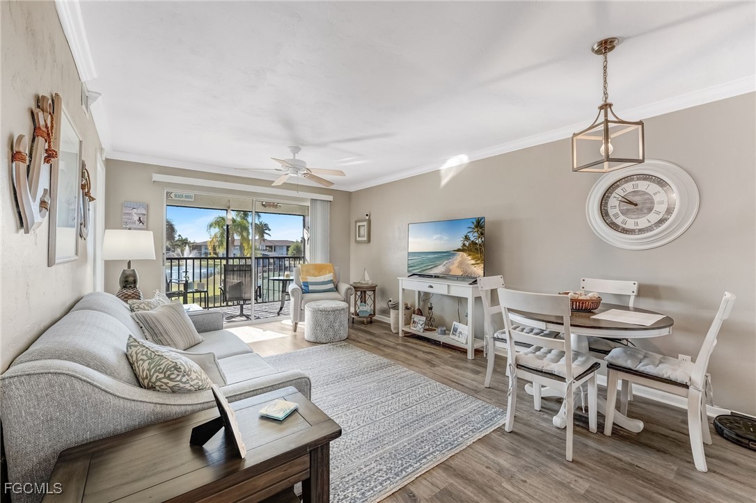 16007 Davis Road, Unit 524 Fort Myers, FL 33908 - Photo 8 of 36 a living room with furniture a clock and a window