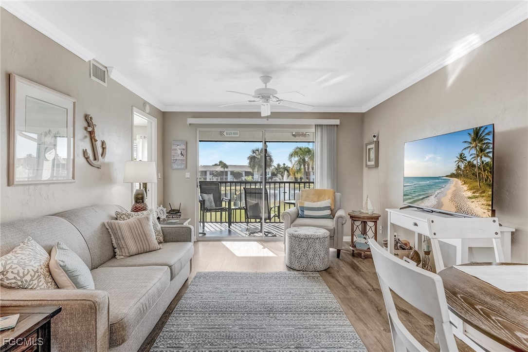 16007 Davis Road, Unit 524 Fort Myers, FL 33908 - Photo 9 of 36 a living room with furniture and a large window with wooden floor