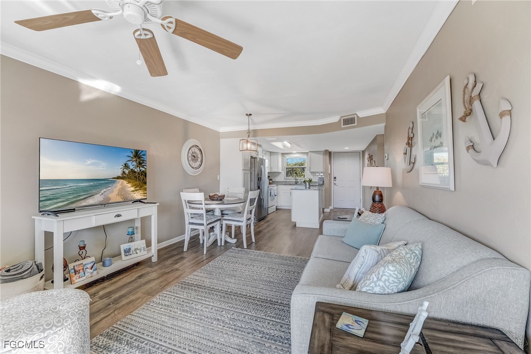 16007 Davis Road, Unit 524 Fort Myers, FL 33908 - Photo 10 of 36 a living room with furniture and a flat screen tv
