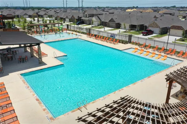 a view of swimming pool with outdoor seating