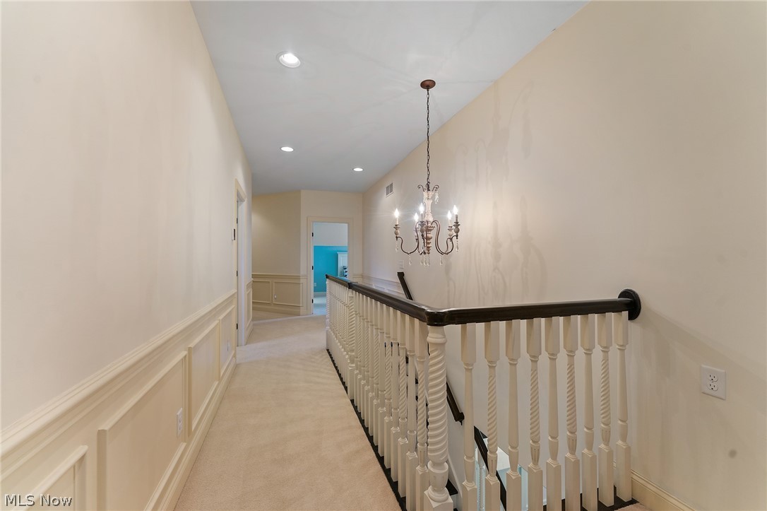 6716 Kyle Ridge Pointe Canfield, OH 44406 - Photo 24 of 43 2nd floor Corridor featuring an inviting chandelier and light carpet