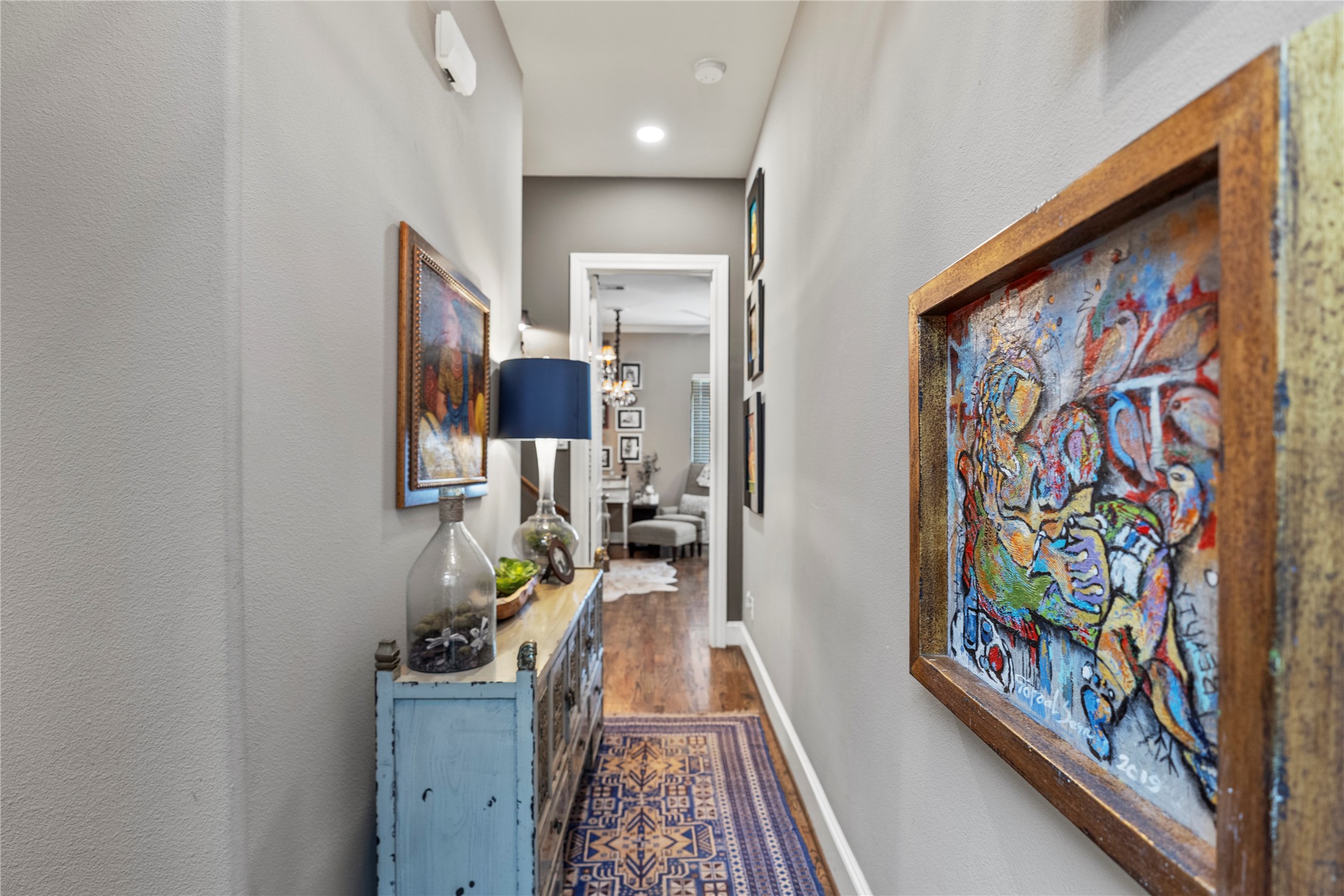 1102 Thompson Street Houston, TX 77007 - Photo 30 of 35 a hallway with painting on the wall and a large mirror