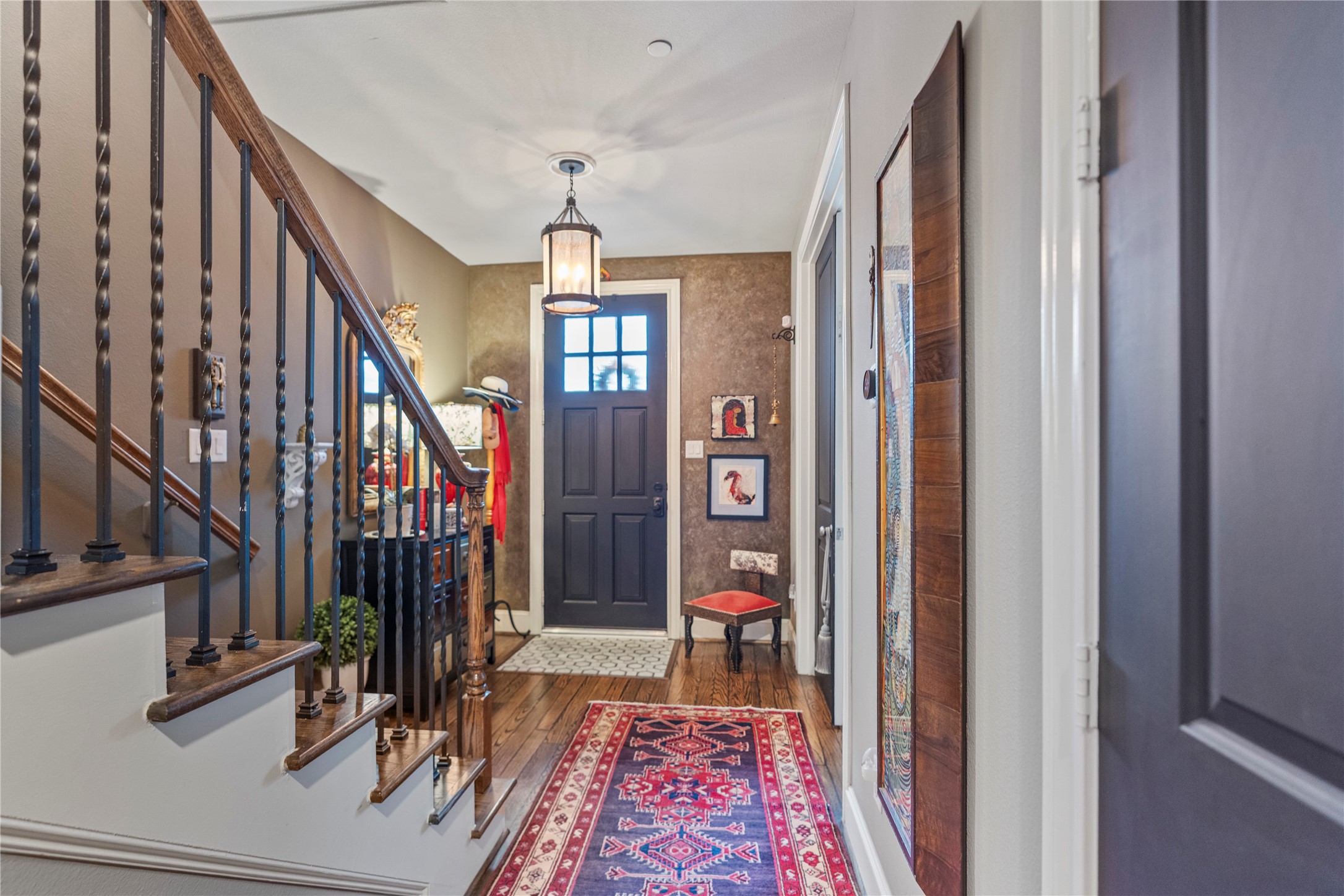 1102 Thompson Street Houston, TX 77007 - Photo 31 of 35 a view of a hallway with wooden floor and stairs