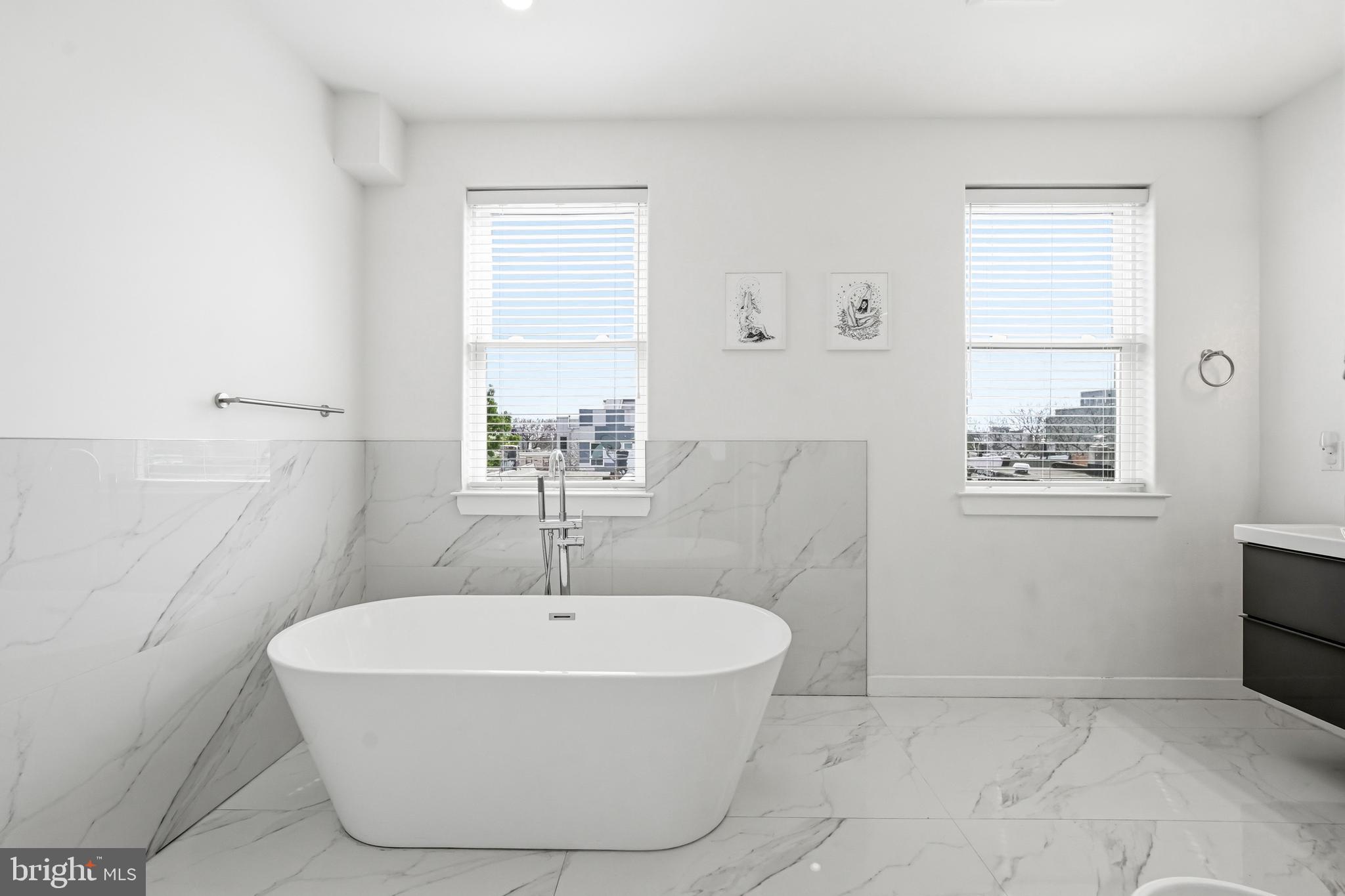 2604 Reed Street Philadelphia, PA 19146 - Photo 25 of 45 a white bath tub sitting in a bathroom next to a window
