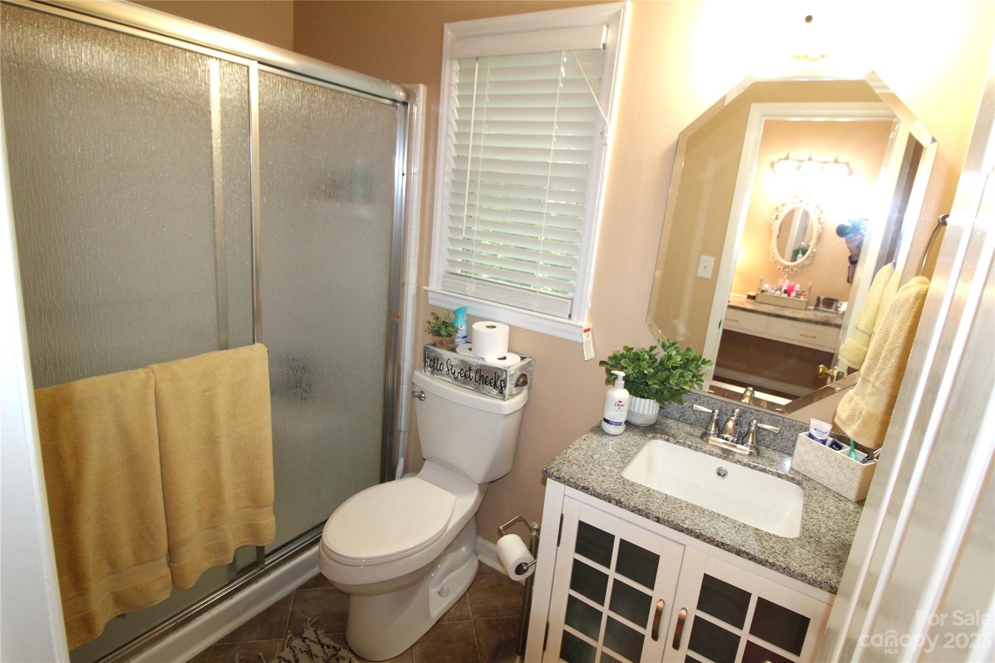 104 McCall Street Clover, SC 29710 - Photo 12 of 22 a bathroom with a granite countertop sink toilet and shower