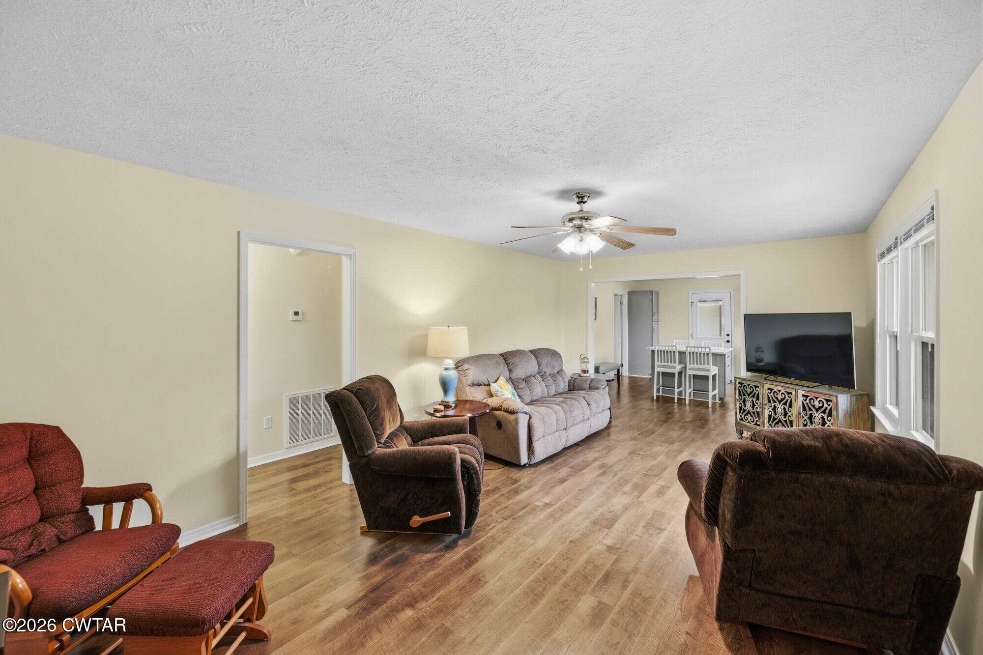 944 Brooksie Thompson Road Decaturville, TN 38329 - Photo 6 of 47 a living room with furniture and a flat screen tv