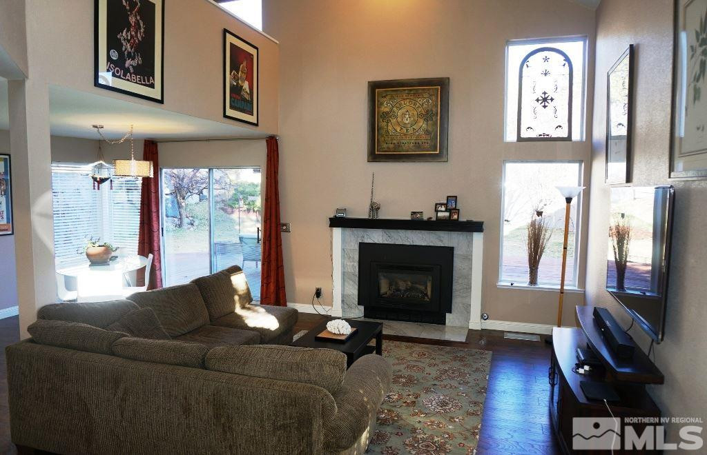 3005 Alpine Creek Road Reno, NV 89519 - Photo 8 of 25 a living room with furniture a flat screen tv and a fireplace