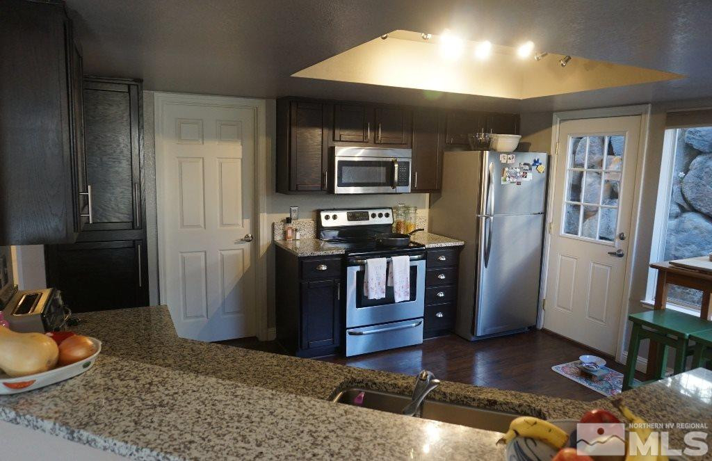 3005 Alpine Creek Road Reno, NV 89519 - Photo 10 of 25 a kitchen with stainless steel appliances granite countertop a refrigerator stove and oven