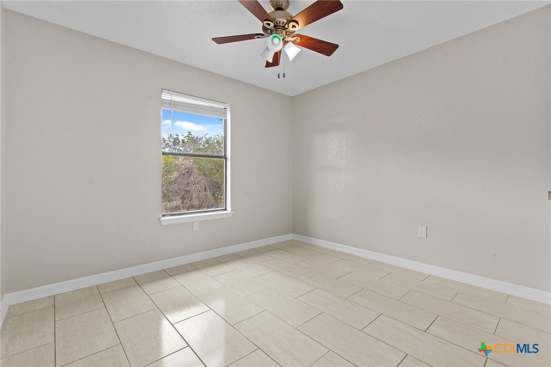 180 County Road 4933 Kempner, TX 76539 - Photo 11 of 24 an empty room with windows and fan