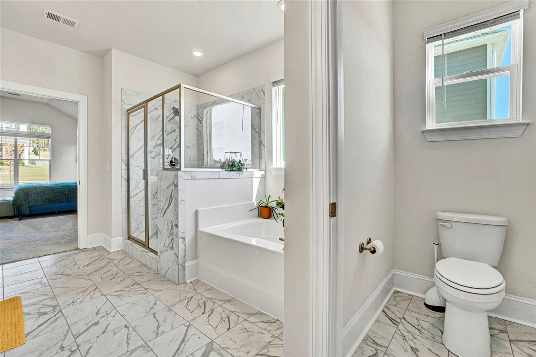 142 Juniper Hill Drive Easley, SC 29642 - Photo 28 of 47 This spacious bathroom offers a relaxing soaking tub and a sleek, tiled shower.
