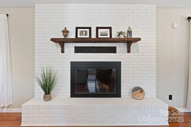 a white house with sink and a fireplace