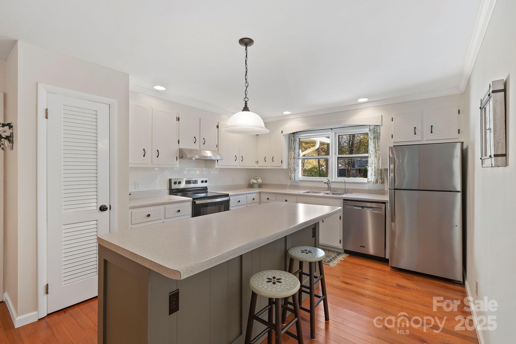 228 Raintree Drive Hendersonville, NC 28791 - Photo 15 of 37 a kitchen with a refrigerator a stove a sink and a refrigerator