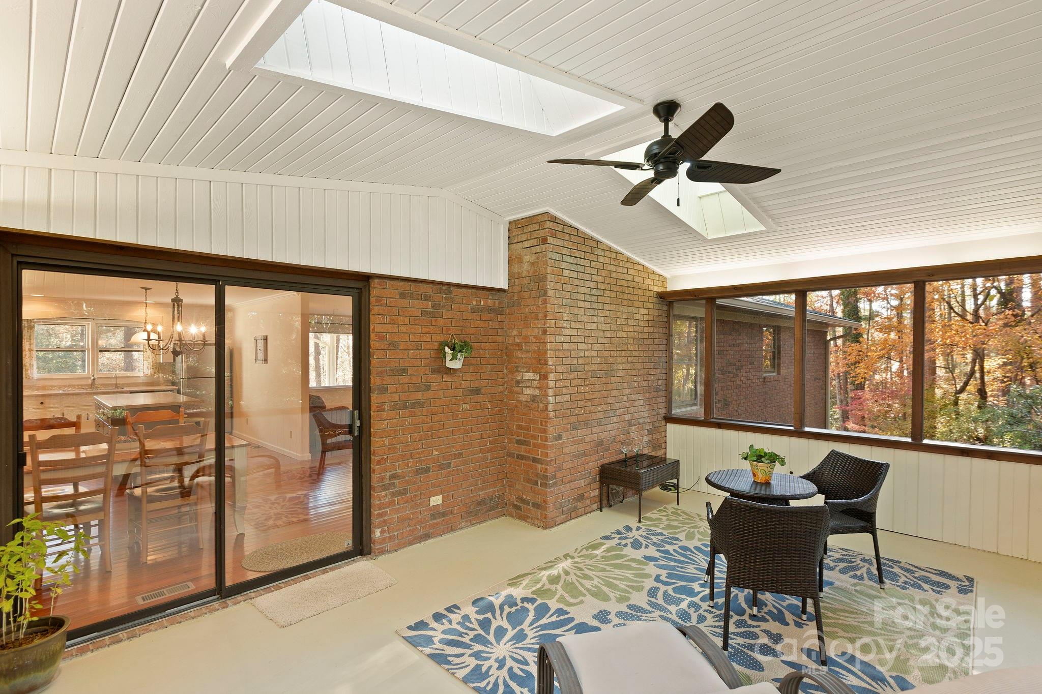 228 Raintree Drive Hendersonville, NC 28791 - Photo 19 of 37 a living room with furniture and a floor to ceiling window