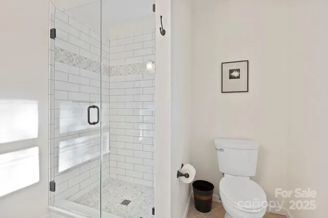 a bathroom with a toilet and shower