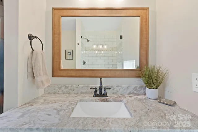 a bathroom with a sink a mirror and a window