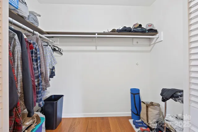 a view of walk in closet with clothes and shoes
