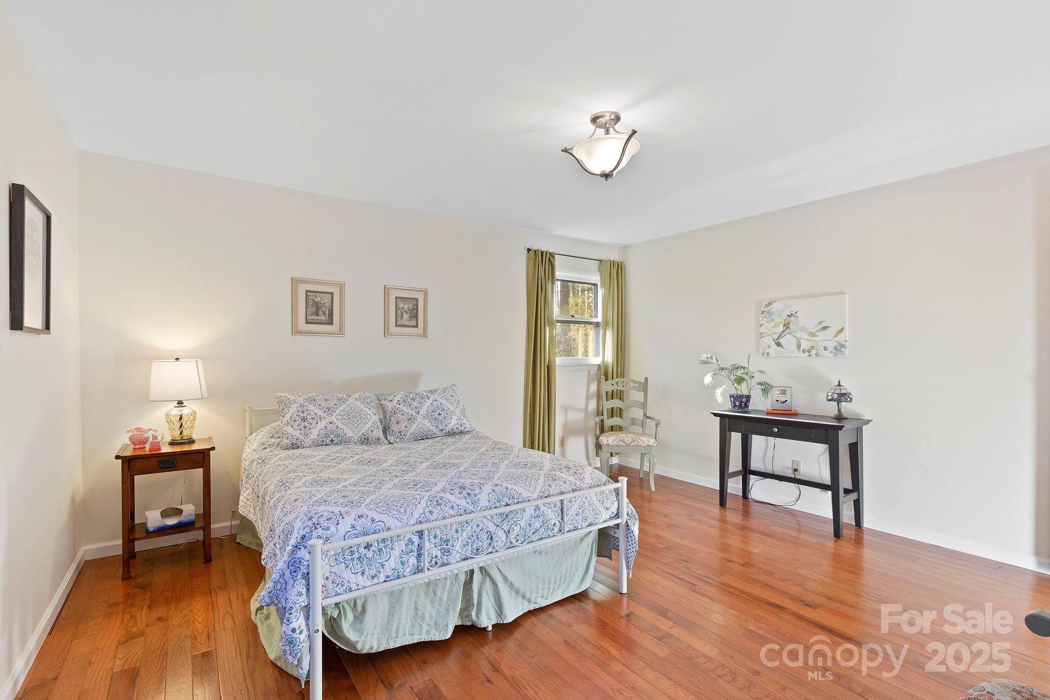 228 Raintree Drive Hendersonville, NC 28791 - Photo 25 of 37 a bedroom with a bed and a table in it