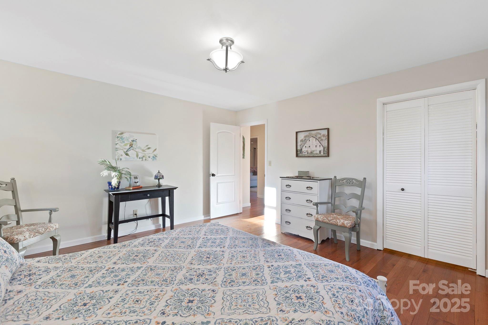 228 Raintree Drive Hendersonville, NC 28791 - Photo 26 of 37 a bedroom with furniture and a chandelier
