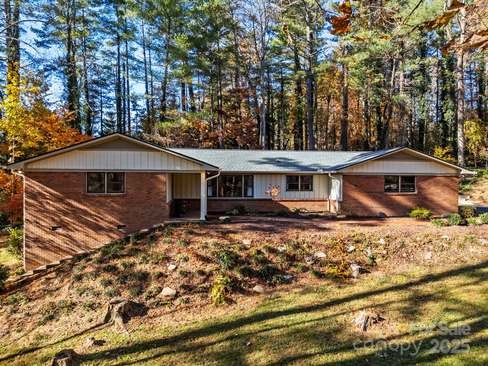 228 Raintree Drive Hendersonville, NC 28791 - Photo 4 of 37 a front view of a house with a yard