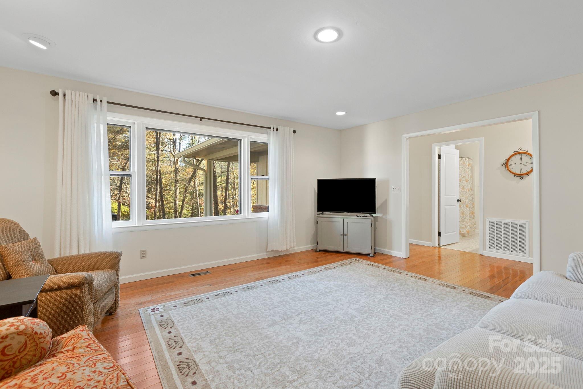 228 Raintree Drive Hendersonville, NC 28791 - Photo 8 of 37 a living room with furniture and a flat screen tv