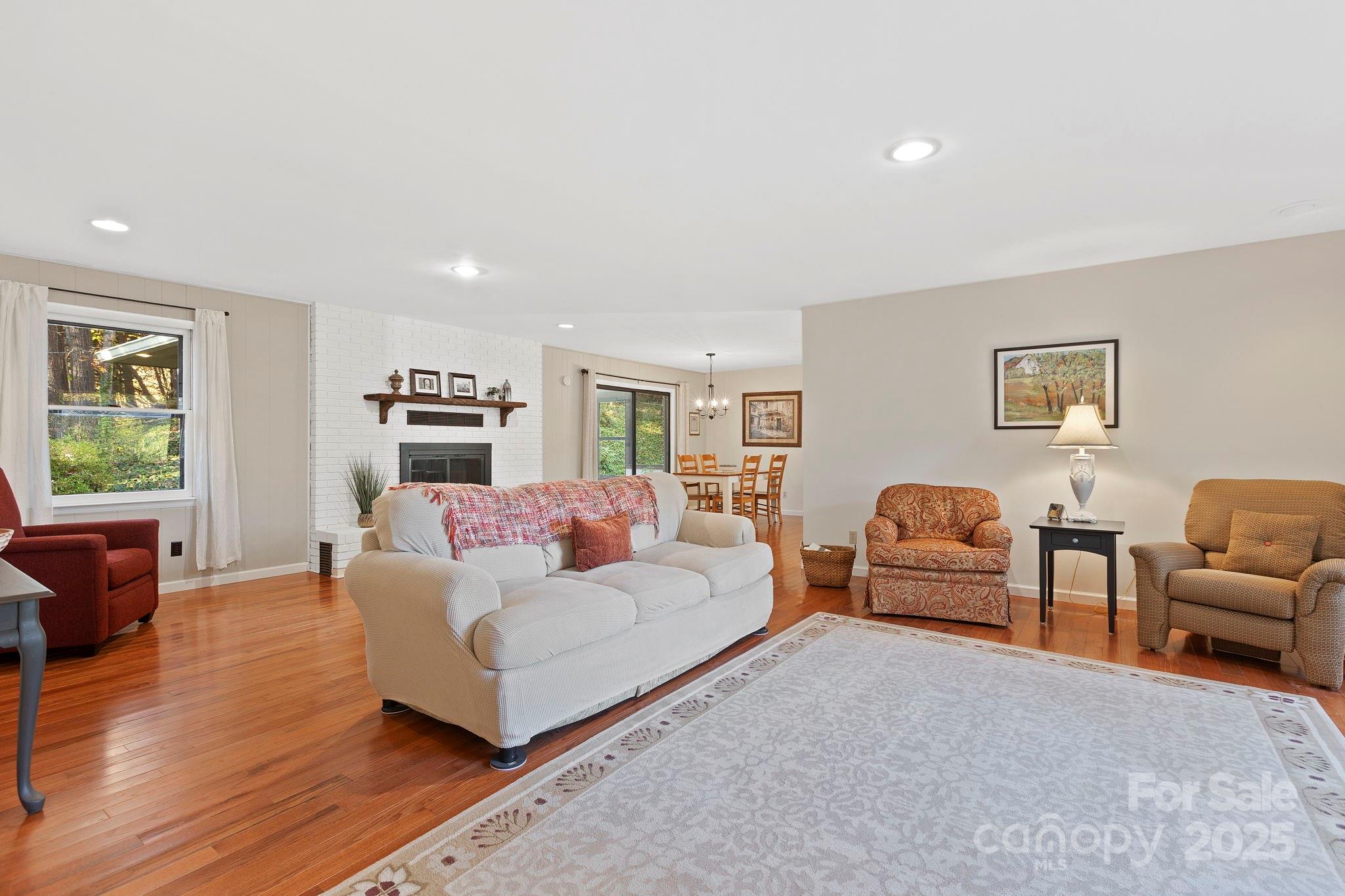 228 Raintree Drive Hendersonville, NC 28791 - Photo 9 of 37 a living room with furniture and a wooden floor