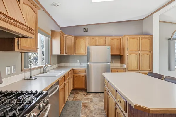 a kitchen with a refrigerator a sink and a stove