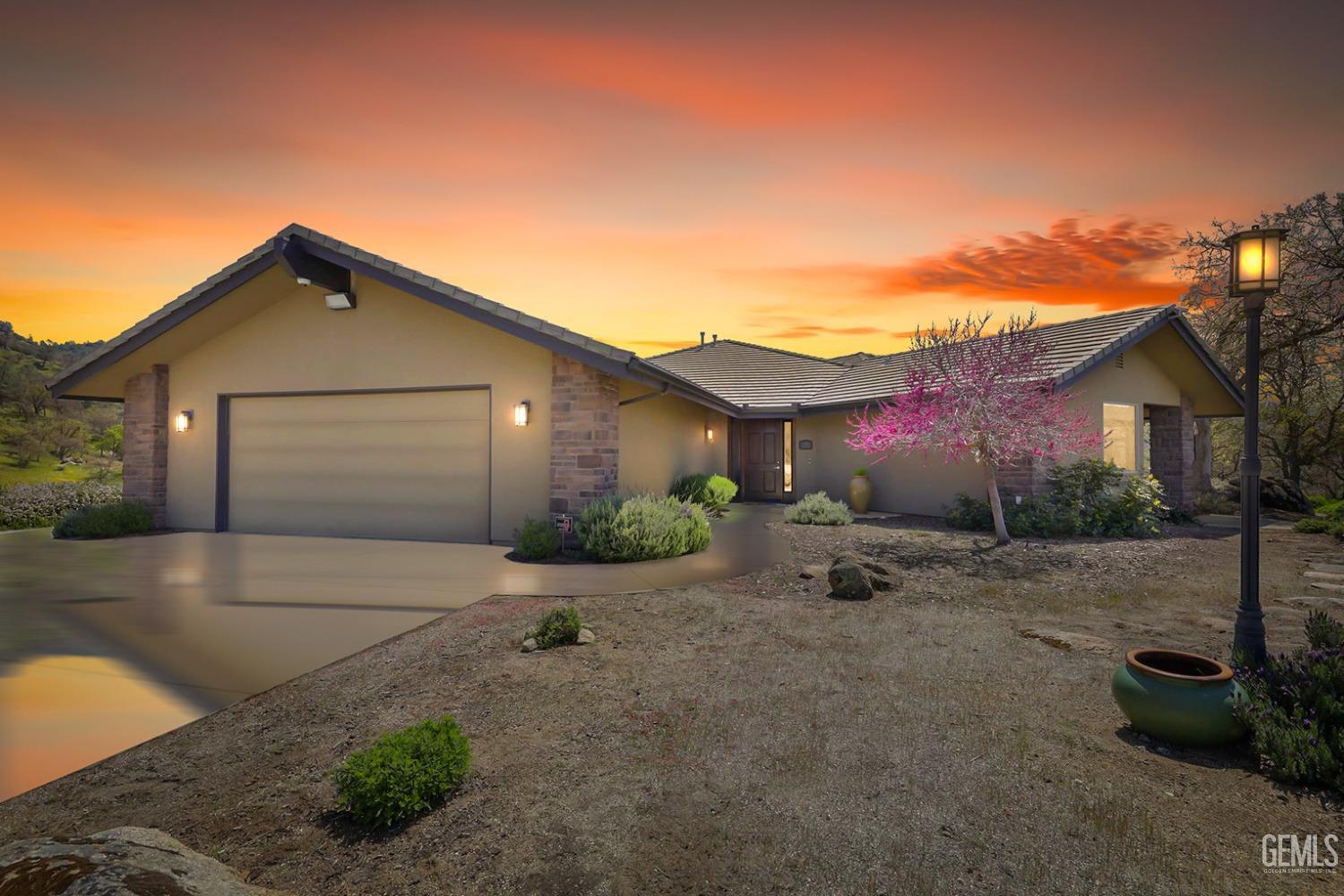 a front view of a house with yard and parking space
