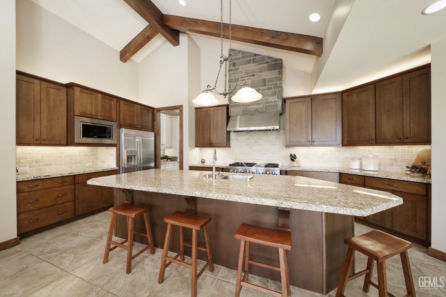 Undisclosed Address Bakersfield, CA 93308 - Photo 13 of 51 a kitchen with a table chairs sink and cabinets
