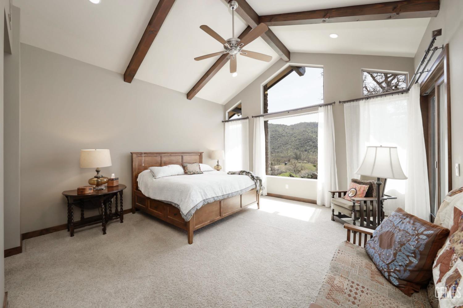 Undisclosed Address Bakersfield, CA 93308 - Photo 17 of 51 a spacious bedroom with a bed a table and chair