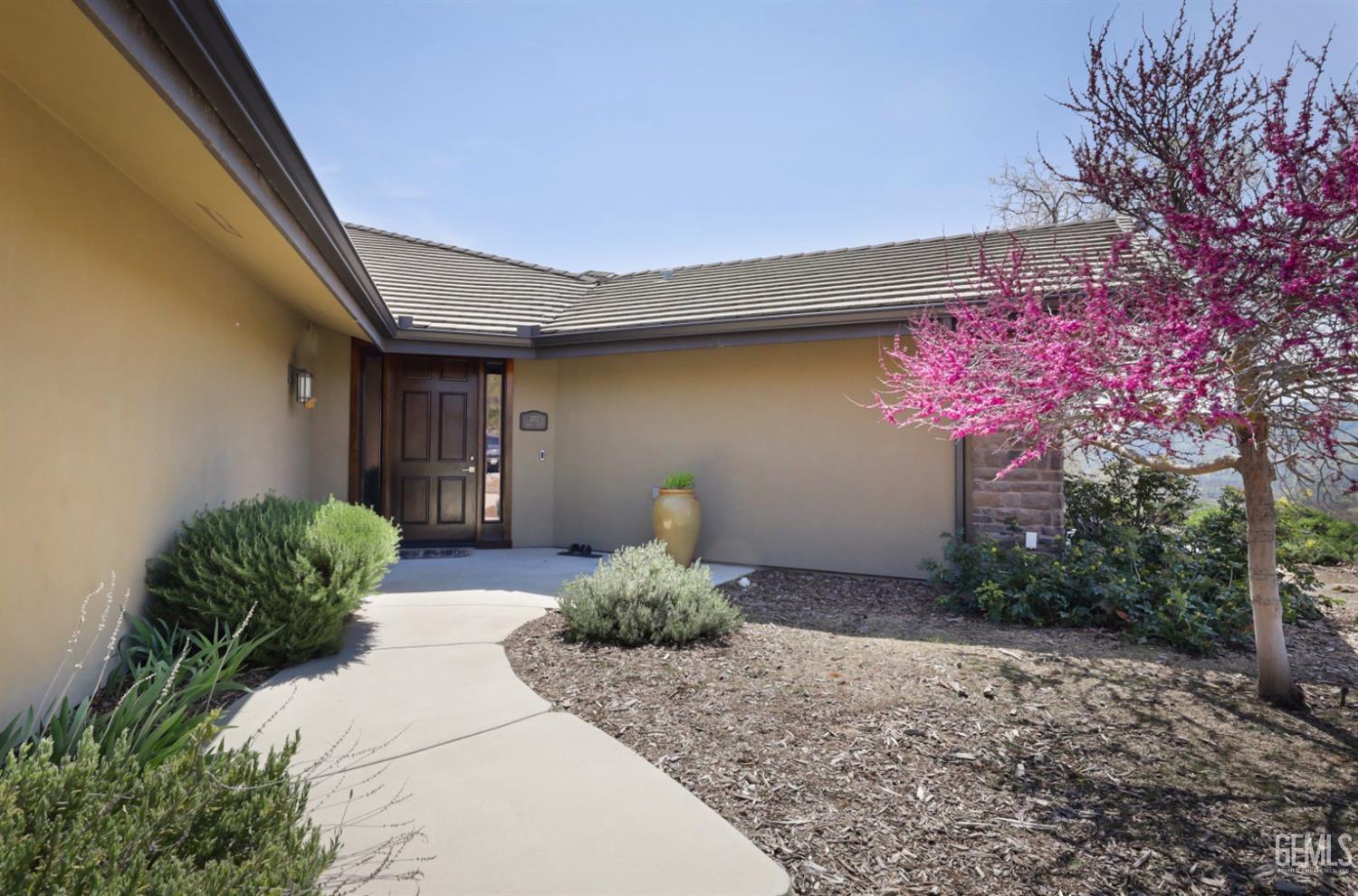 Undisclosed Address Bakersfield, CA 93308 - Photo 35 of 51 a front view of a house with garden