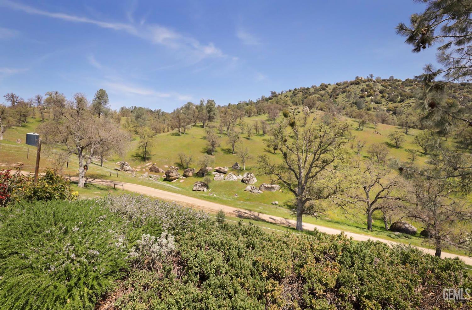 Undisclosed Address Bakersfield, CA 93308 - Photo 48 of 51 a view of a yard with a building in the background