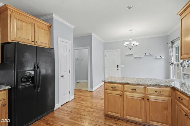 a view of a kitchen with granite countertop cabinets and stainless steel appliances
