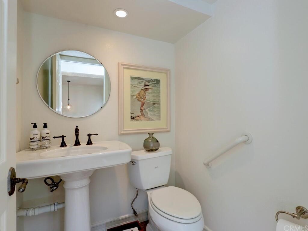 22 Chelsea Dana Point, CA 92629 - Photo 11 of 27 a bathroom with a toilet a sink and mirror