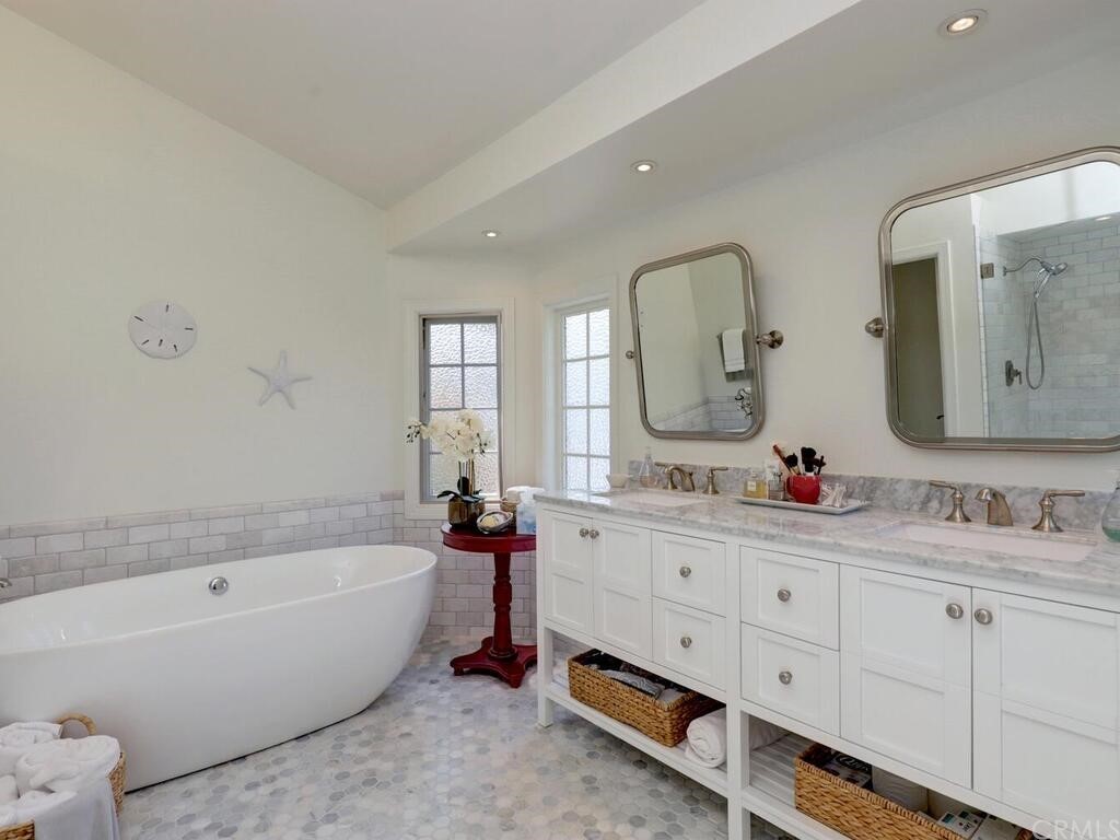 22 Chelsea Dana Point, CA 92629 - Photo 16 of 27 a bathroom with a bathtub a double vanity sink and mirror