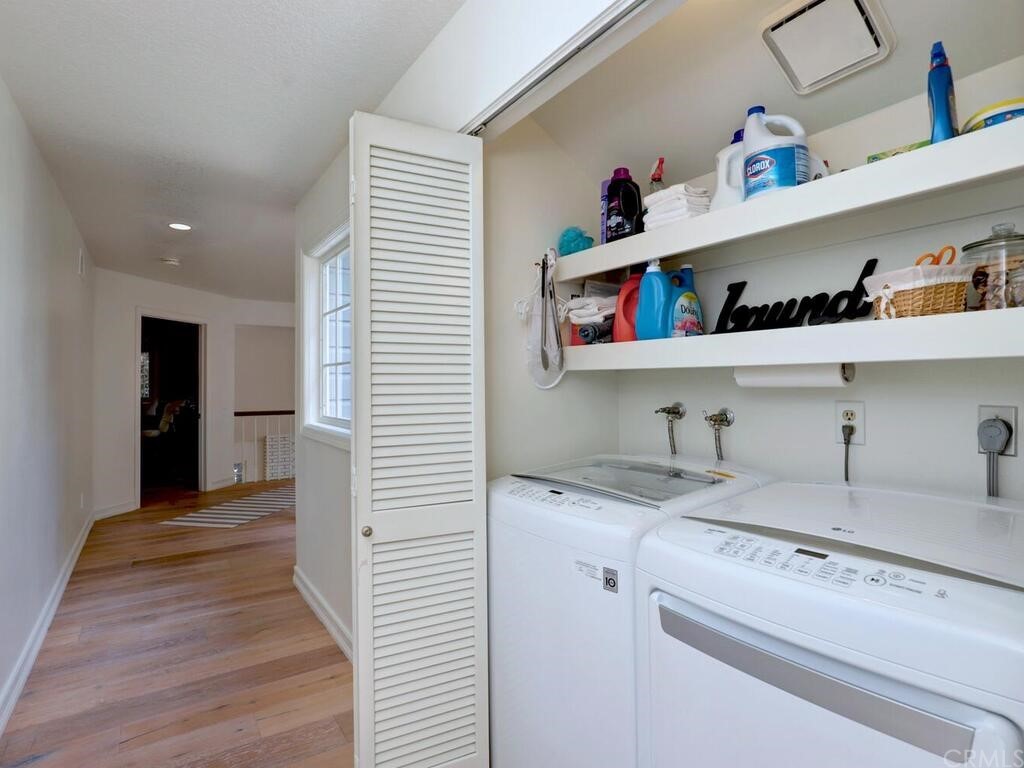 22 Chelsea Dana Point, CA 92629 - Photo 21 of 27 a kitchen with a sink cabinets and a wooden floor