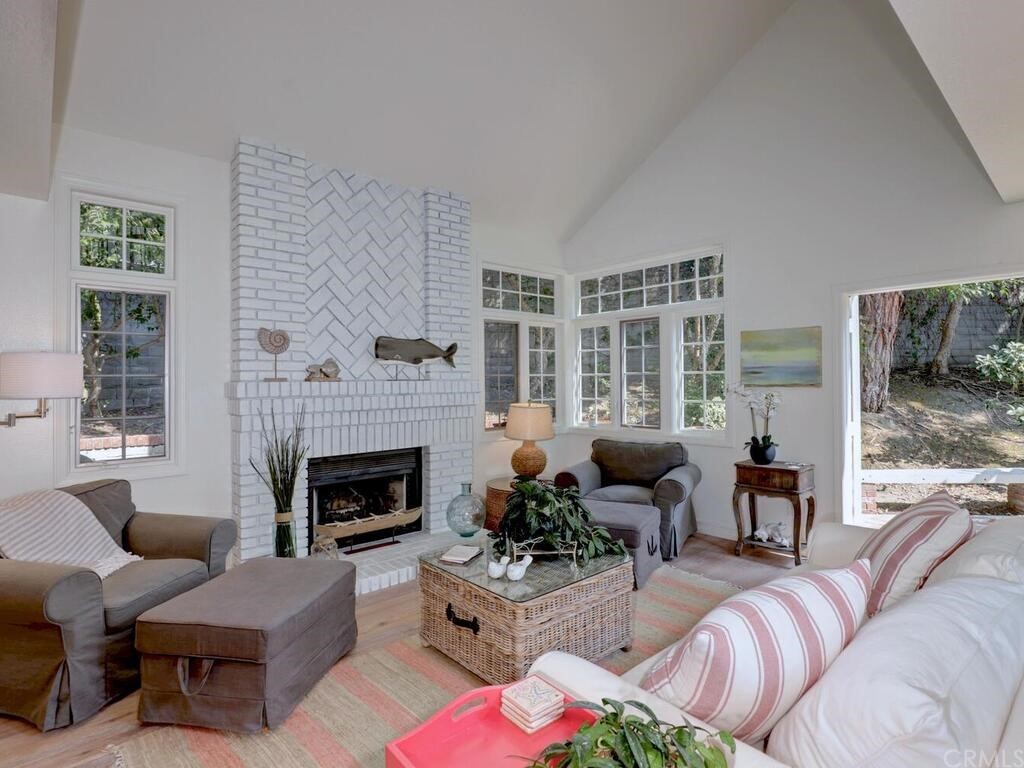 22 Chelsea Dana Point, CA 92629 - Photo 7 of 27 a living room with furniture large window and a fireplace