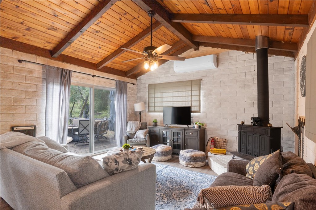 4500 Gage Irving Road Paso Robles, CA 93446 - Photo 5 of 16 a living room with furniture a fireplace and a flat screen tv