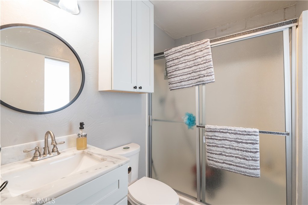 4500 Gage Irving Road Paso Robles, CA 93446 - Photo 10 of 16 a bathroom with a sink a toilet and a mirror