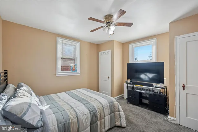 a bedroom with a large bed and a flat screen tv