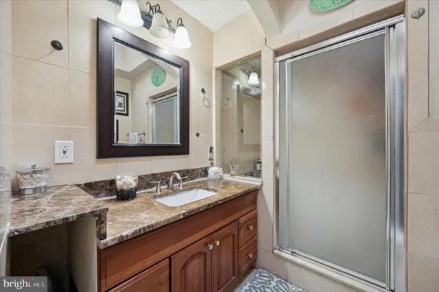 a bathroom with a granite countertop sink two mirror and a