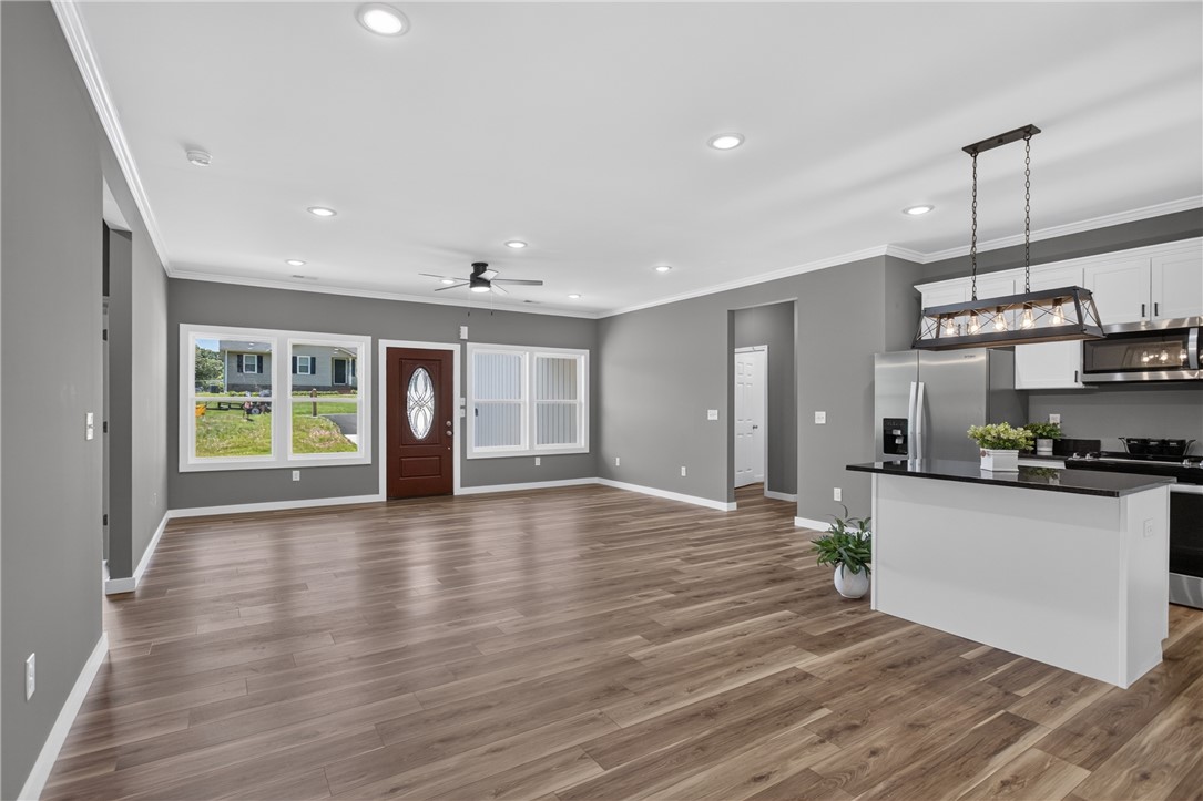 223 Maple Drive Anderson, SC 29621 - Photo 15 of 45 An open-concept living space with lustrous hardwood floors flows into a kitchen featuring modern appliances.