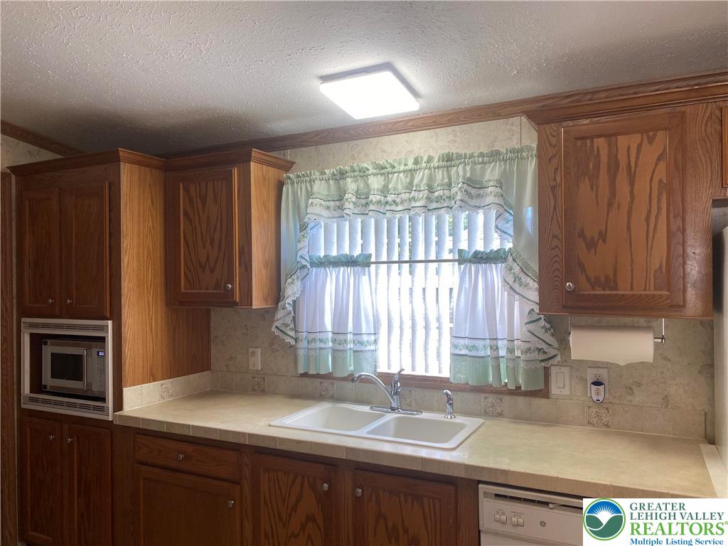 82 Pheasant Drive Kutztown, PA 19530 - Photo 12 of 32 a kitchen with a sink a window and cabinets