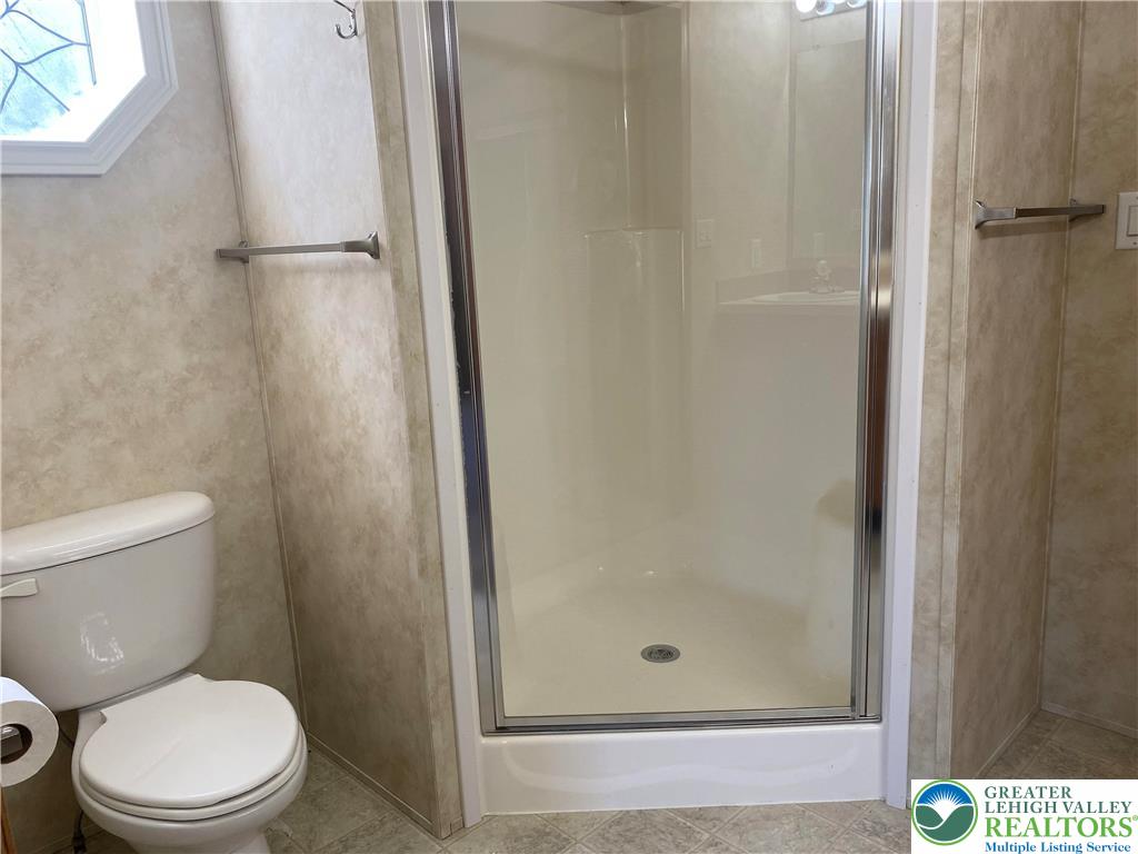 82 Pheasant Drive Kutztown, PA 19530 - Photo 17 of 32 a bathroom with a shower and a toilet