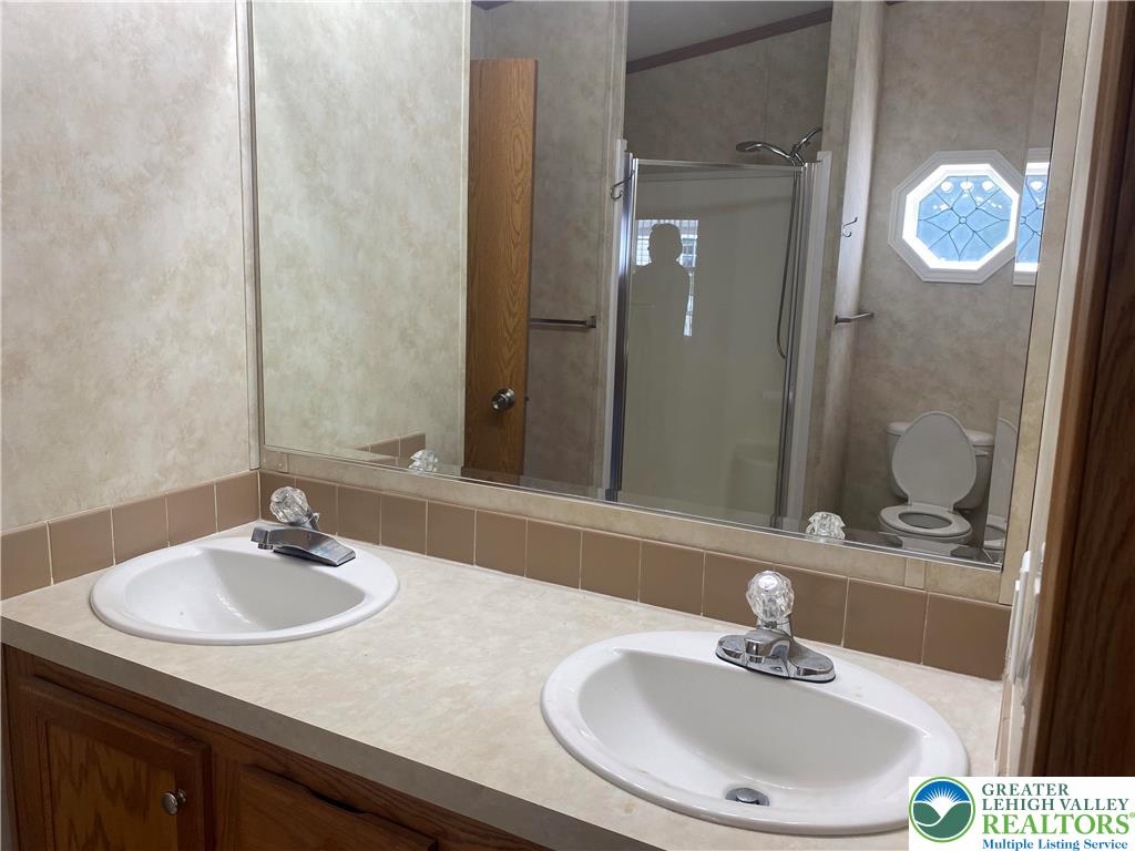 82 Pheasant Drive Kutztown, PA 19530 - Photo 18 of 32 a bathroom with a sink and a mirror