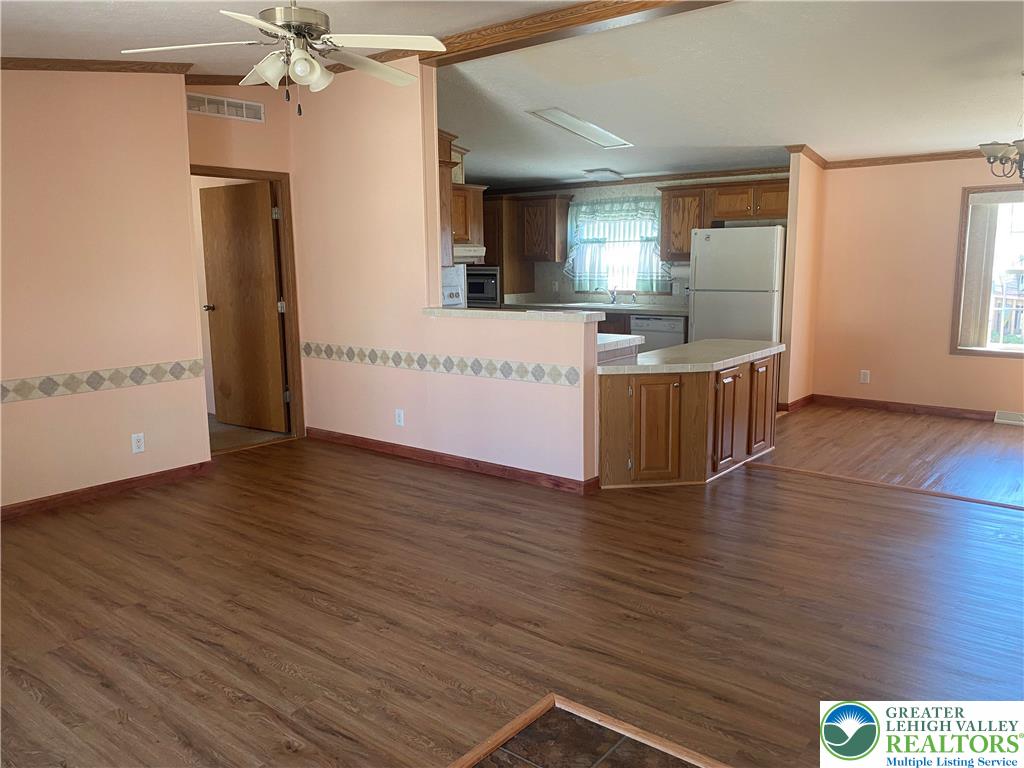 82 Pheasant Drive Kutztown, PA 19530 - Photo 6 of 32 an empty room with wooden floor and windows