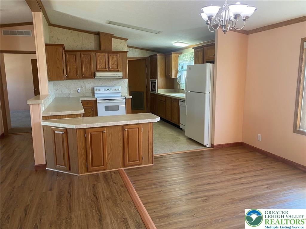 82 Pheasant Drive Kutztown, PA 19530 - Photo 9 of 32 a kitchen with stainless steel appliances granite countertop a refrigerator a sink dishwasher and a stove with wooden floors