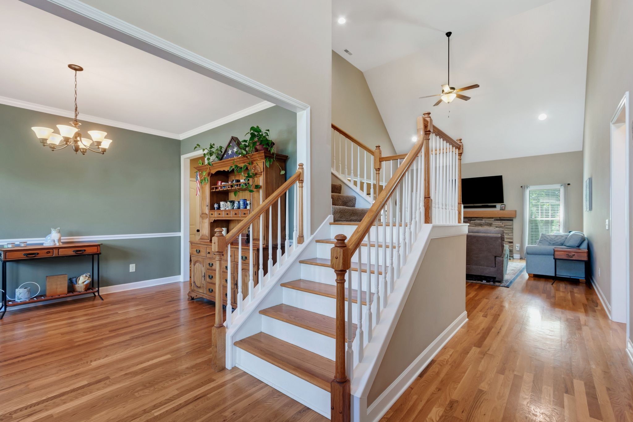1004 Rudder Drive Spring Hill, TN 37174 - Photo 4 of 50 a view of a livingroom with furniture stairs a chandelier and wooden floor