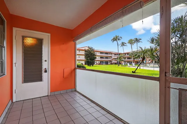 a view of a swimming pool with an outdoor seating and a yard